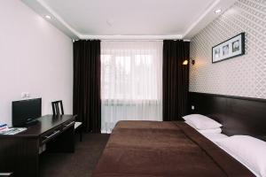 Кровать или кровати в номере Загородный Клуб Олимпия