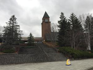 a building with a tower with a steeple and stairs at Auto Resort Takino in Sapporo