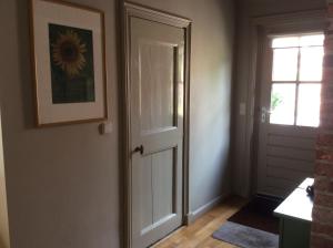 a door in a room with a window and a picture at B&B Oudeschans in Oudeschans
