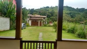 Casa com Piscina para temporada em Paraty - Casa Nova e Aconchegante في باراتي: منظر على ساحة من النافذة