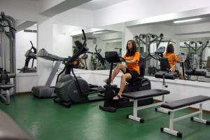 a woman sitting on a treadmill in a gym at Makronisos Village in Ayia Napa
