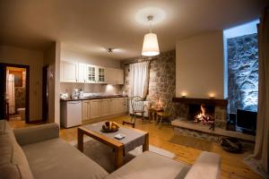 a living room with a couch and a fireplace at Levanta Guesthouse in Synikia Mesi Trikalon