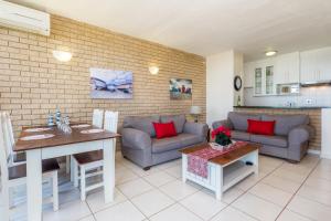 a living room with a couch and a table at 33 Boulder Bay, Ballito in Ballito