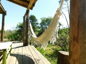 a hammock hanging from a porch of a house at Casa Aguai in La Paloma