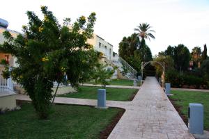 a walkway in a park next to a building at Makronisos Village in Ayia Napa
