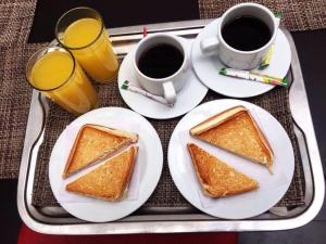 a tray with two slices of toast and two cups of coffee at Hotel Bogota Virrey in Bogotá