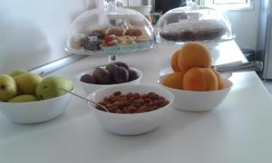 a table topped with bowls of different types of fruit at B&B Maison Blanche in Caltagirone