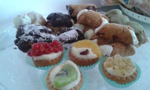 a plate of different types of pastries on a table at B&B Maison Blanche in Caltagirone