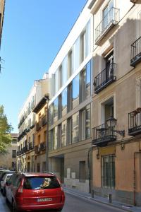 a red car parked in front of a building at Aspasios Atocha Apartments in Madrid