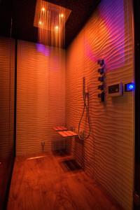 a room with a shower with purple lights on the wall at Roma Luxus Hotel in Rome +37 photos