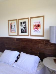 um quarto com quatro quadros na parede acima de uma cama em Itacimirim Village 2 Quartos em Itacimirim