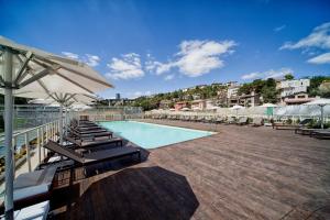 a swimming pool with lounge chairs and an umbrella at Ortakoy Aparts in Istanbul