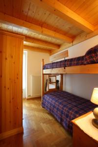 a bedroom with two bunk beds in a room at Casa Rubino Lake & Dolomites in Molveno