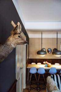 a deer head on the wall of a dining room at Domaine Des Agnelles in Villedaigne