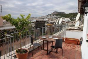 a balcony with a table and chairs and a view at Roof Top Studio in Athens