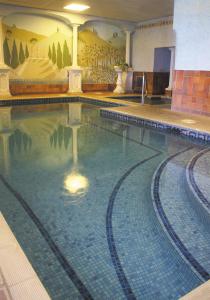 a swimming pool in a building with water in it at Grand Hotel Swanage in Swanage