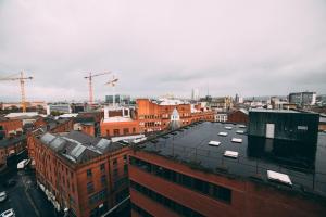 an aerial view of a city with buildings and cranes at City centre penthouse apartment in Belfast