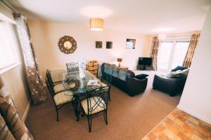 a living room with a table and chairs at City centre penthouse apartment in Belfast