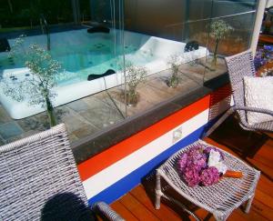 a room with two chairs and a swimming pool at Hotel Pousada Oosterhuis in Castro