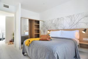 a bedroom with a large bed with a bunch of bananas on it at Aspasios Atocha Apartments in Madrid