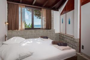 Posteľ alebo postele v izbe v ubytovaní Beach Time Villa