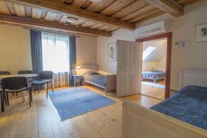 a bedroom with two beds and a table and a dining room at Tampere Maja in Tartu