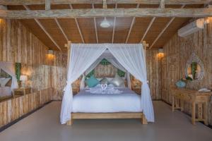 a bedroom with a bed with a canopy at Bella Kita Mountain Retreat & Spa in Klungkung +33 photos
