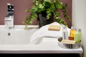a bathroom with a sink and two bottles of liquid at Vine Village in Niagara-on-the-Lake +81 photos