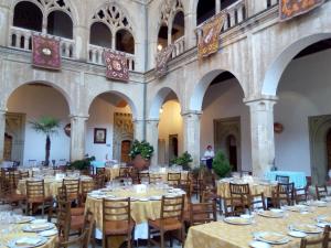 a dining room with tables and chairs in a building at Hospederia del Real Monasterio in Guadalupe