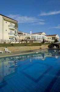 a large swimming pool in front of a building at Hotel Αchillion Grevena in Grevena