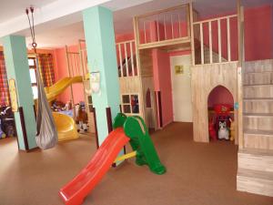 a kids room with a slide and a play area at Pension Borůvka in Špindlerův Mlýn