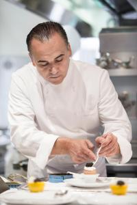 a chef in a kitchen preparing food on a plate at Trump International New York in New York