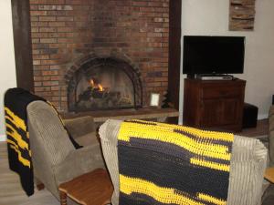 a living room with two chairs and a fireplace at Husky House in Bessemer