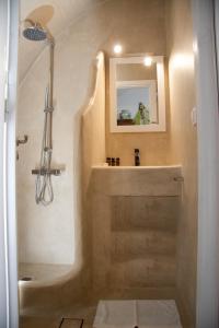a bathroom with a tub and a sink and a mirror at Sophia Areopoli Guesthouse in Areopoli