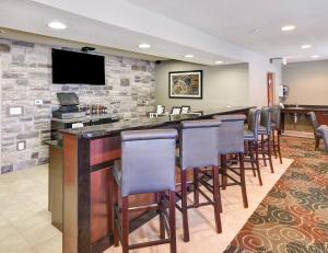 a bar with bar stools in a hotel room at Cobblestone Inn & Suites - Big Lake in Big Lake