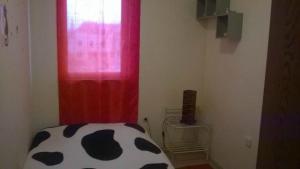 a room with a red curtain and a window at Apartment Roksy in Supetar