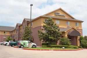a hotel building with cars parked in front of it at Extended Stay America Suites - Houston - Sugar Land in Sugar Land