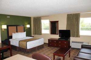 a hotel room with a bed and a flat screen tv at Extended Stay America Suites - Houston - Katy Freeway - Energy Corridor in Houston