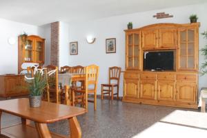 a living room with a television and a dining room at Piso Jover in Lloret de Mar