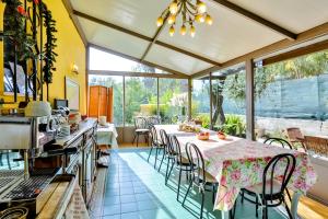a kitchen with a table and chairs in a room at Cà De Rossana Bed&Breakfast in Sanremo