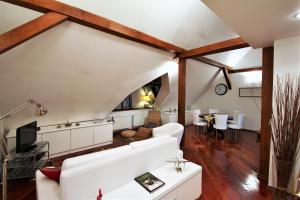 a living room with a white couch and wooden beams at Residence Salvator - by Prague City Apartments in Prague
