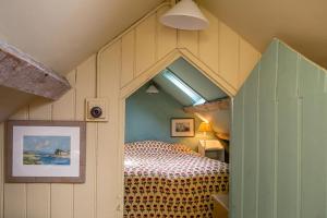 a bedroom with a bed in a house at Aberdaron Cottage 2 Bryn Chwilog in Aberdaron