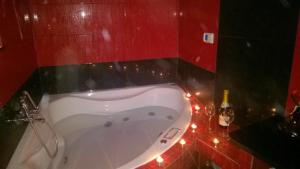 a bath tub in a bathroom with christmas lights at Apartament u Jawora in Grywałd