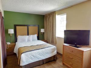 a bedroom with a bed and a flat screen tv at Extended Stay America Suites - Boston - Peabody in Peabody