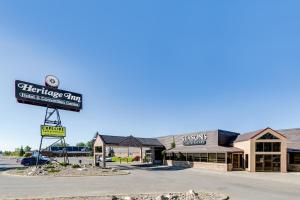 a building with a sign in front of a store at Heritage Inn Hotel & Convention Centre - Moose Jaw in Moose Jaw