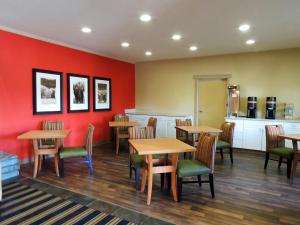 a restaurant with tables and chairs and red walls at Extended Stay America Suites - Fairbanks - Old Airport Way in Fairbanks