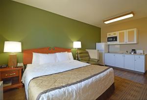 a hotel room with a bed and a kitchen at Extended Stay America Suites - Fairbanks - Old Airport Way in Fairbanks