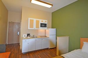 a kitchen with a white refrigerator and a microwave at Extended Stay America Suites - Fairbanks - Old Airport Way in Fairbanks