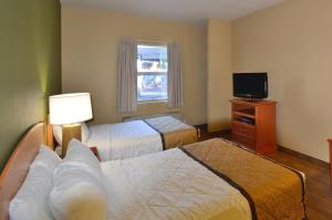 a hotel room with two beds and a television at Extended Stay America Suites - Fairbanks - Old Airport Way in Fairbanks