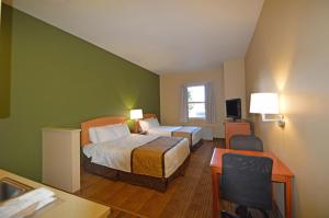a hotel room with two beds and a desk at Extended Stay America Suites - Fairbanks - Old Airport Way in Fairbanks